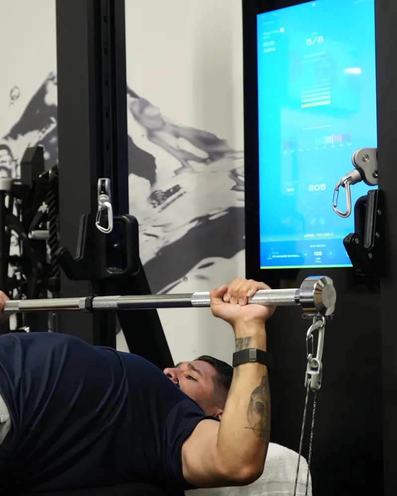 Dr. Rodriguez performing a bench press on a smart cable machine