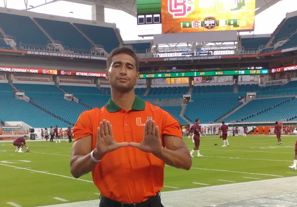 Alexzander Rodriguez on the University of Miami football sideline as a student athletic trainer