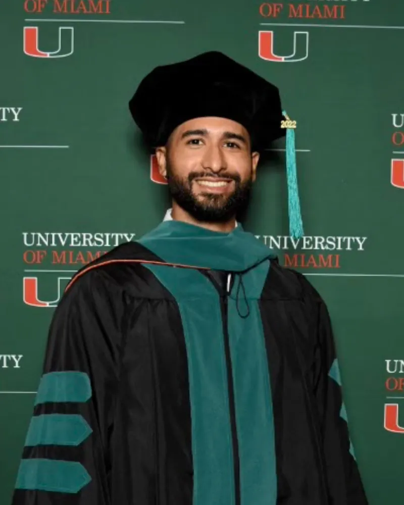 Alexzander Rodriguez in doctoral graduation regalia